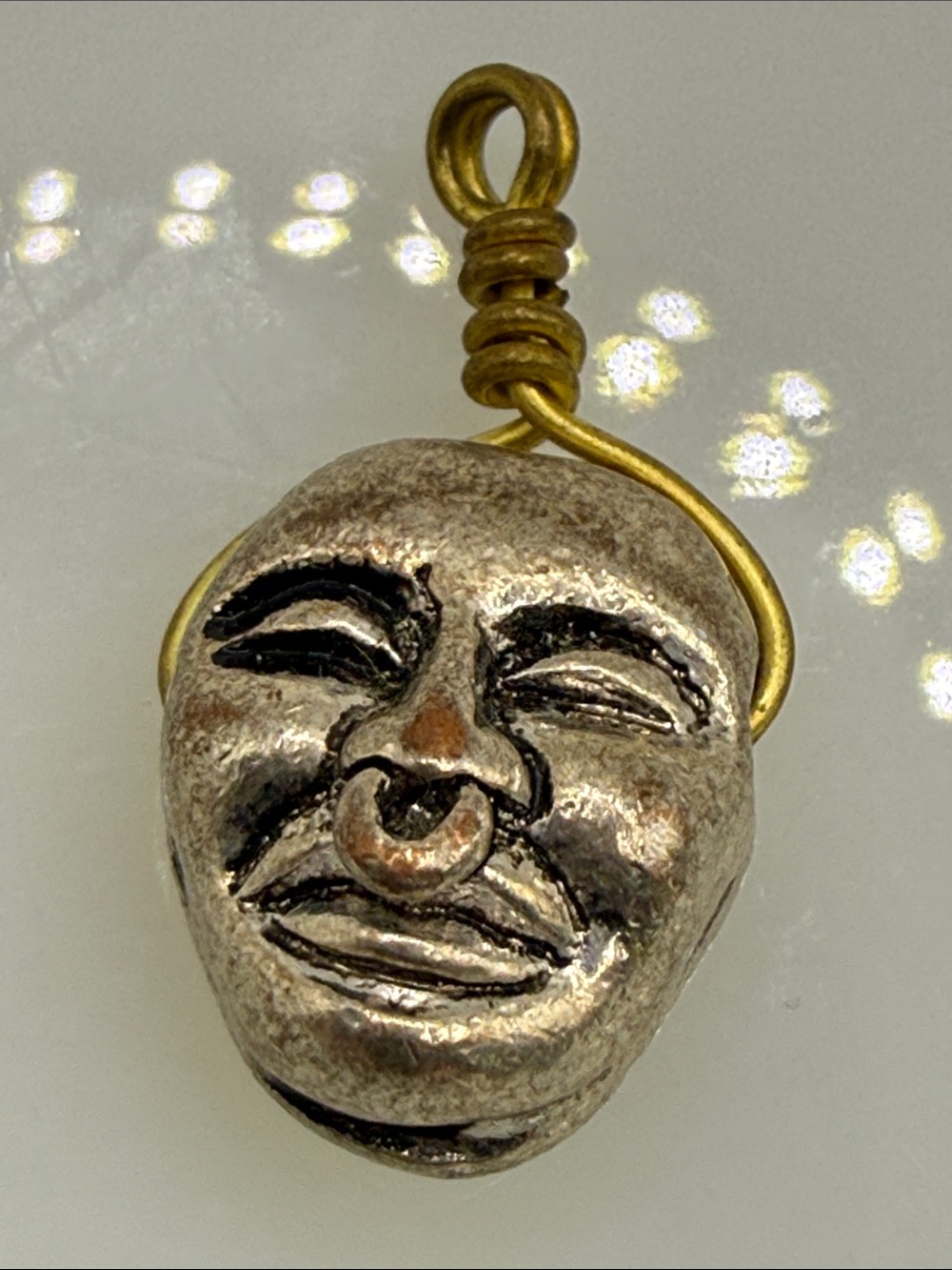 Unusual distressed metal creepy dual sided spinning face charm brutalist pendant